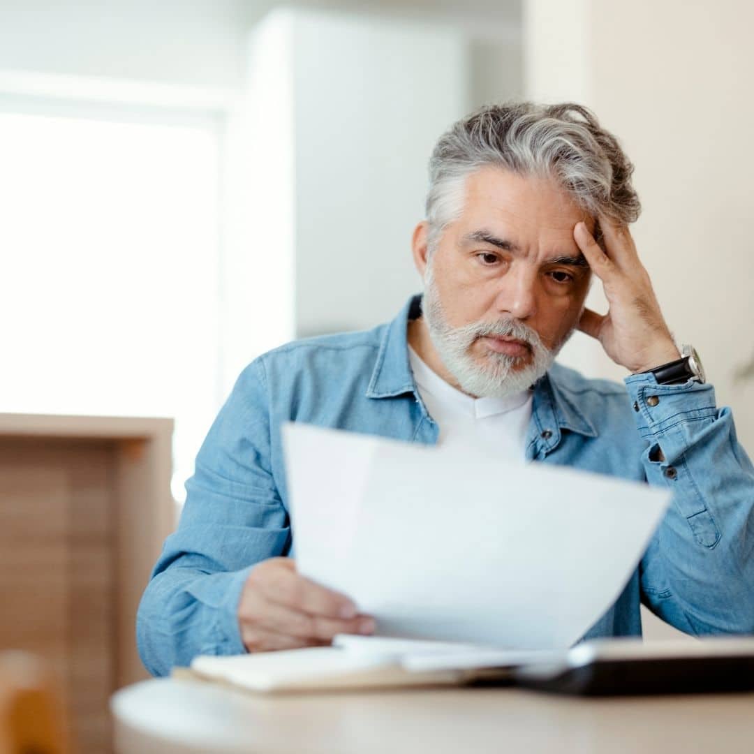 Man looking worried at a high electric bill
