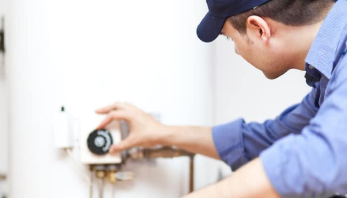 Technician Adjusting Water Heater